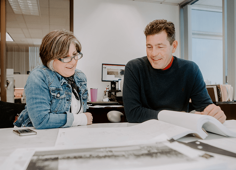 Two colleagues reviewing project plans together
