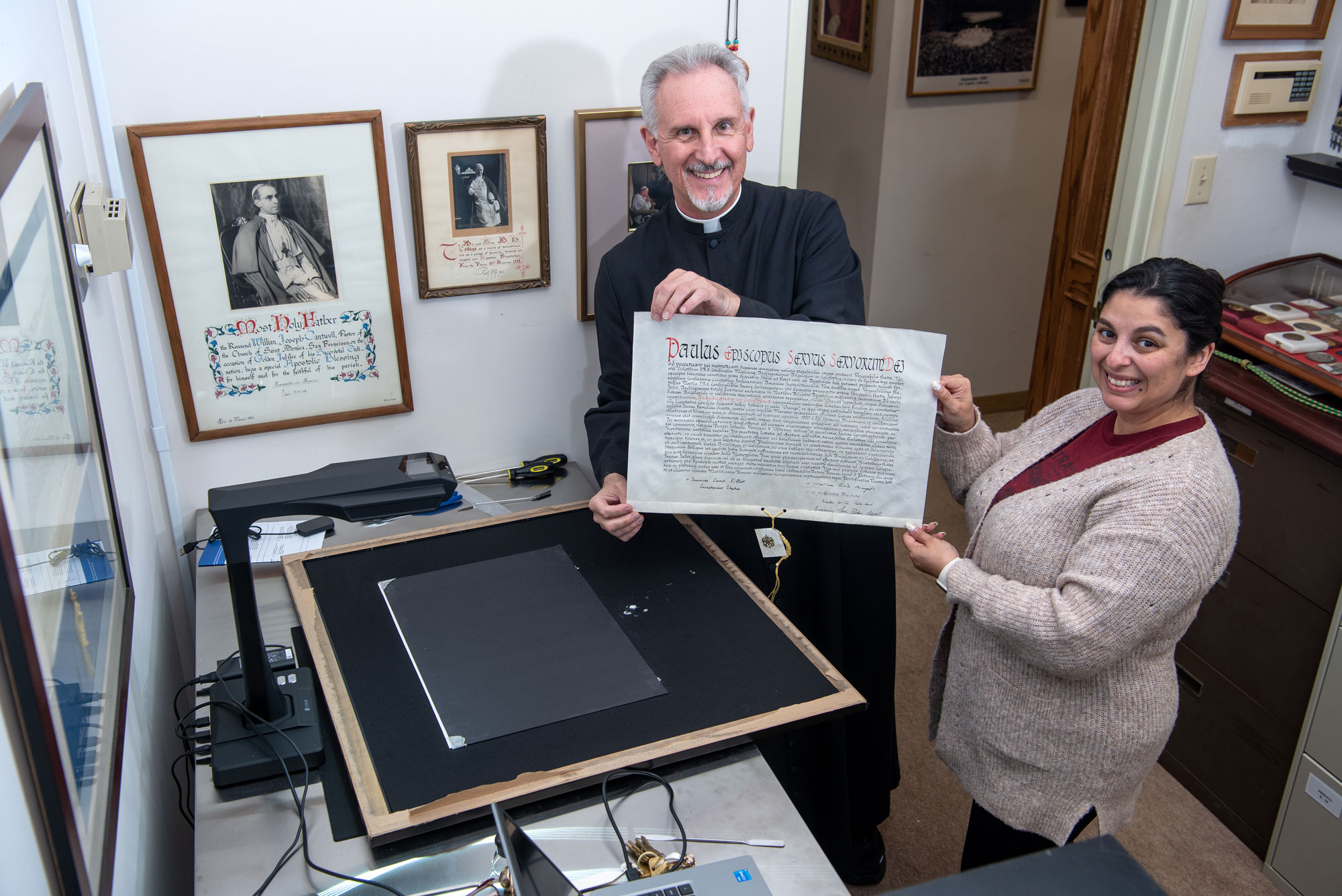 Diocesan archives staff handling a historic document